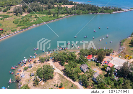 Aerial top view of tourist boats in beach shore, river, pond or lake in summer season. Nature landscape background, Thailand. Aerial top view of tourist boats in beach shore, river, pond or lake in summer season. Nature landscape background, Thailand. 107174942