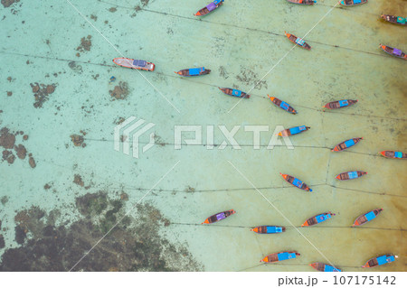 Aerial top view of tourist boats in beach shore, river, pond or lake in summer season. Nature landscape background, Thailand. 107175142