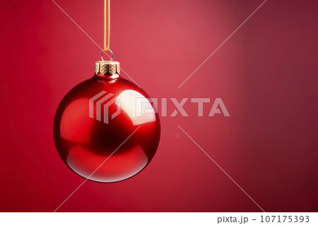 red Christmas ball on a bright background.  107175393
