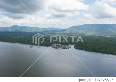 Aerial view of fishing trap net in canel with fisherman urban city village town houses, lake or river. Nature landscape fisheries and fishing tools at Pak Pha, Songkhla, Thailand. Aquaculture farming Aerial view of fishing trap net in canel with fisherman urban city village town houses, lake or river. Nature landscape fisheries and fishing tools at Pak Pha, Songkhla, Thailand. Aquaculture farming 107175517