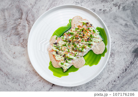 Shrimp tartare with sesame sauce and wasabi cream on a white plate Shrimp tartare with sesame sauce and wasabi cream on a white plate 107176286