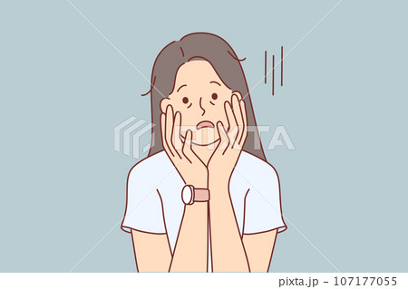 Tired woman with exhausted appearance touches face with hands and suffers from lack of motivation Tired woman with exhausted appearance touches face with hands and suffers from lack of motivation 107177055