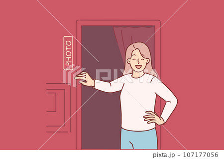 Woman stands near photo booth and laughs, feeling surge of positive emotions before photoshoot 107177056
