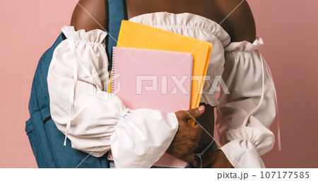 Crop black transgender student holding folder and notebook 107177585