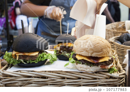 Black hamburgers, street fast food Black hamburgers, street fast food 107177983