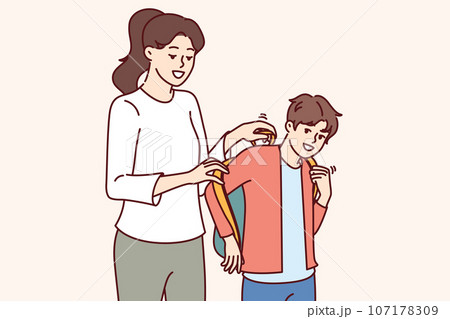 Mother helps son get ready for school and put on backpack with textbooks and office supplies 107178309