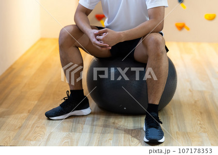 ジムで体を鍛える若い男性 ジムで体を鍛える若い男性 107178353