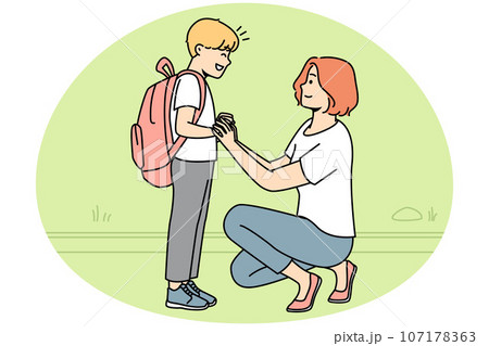 Smiling mother seeing small son to school 107178363