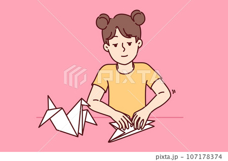Little girl makes origami bird by folding paper animals and developing own creativity 107178374