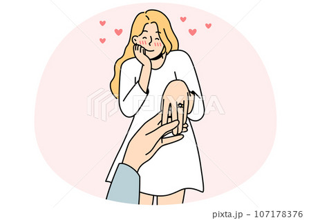 Happy woman with ring on finger 107178376