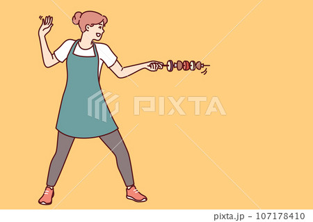 Housewife woman with vegetable kebab stands in swordsman pose and uses skewer instead of sword 107178410