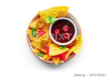 Spicy nachos. Mexican nacho chips, overhead flat lay shot with bbq sauce 107178531