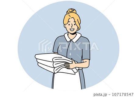 Smiling housekeeper with stack of towels 107178547