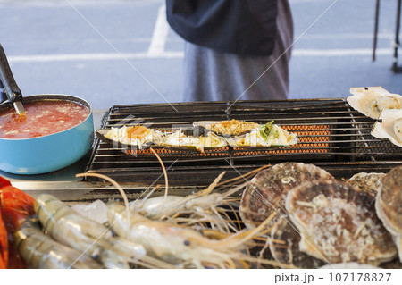 Scallops grilled on street market in Phuket, Thailand 107178827