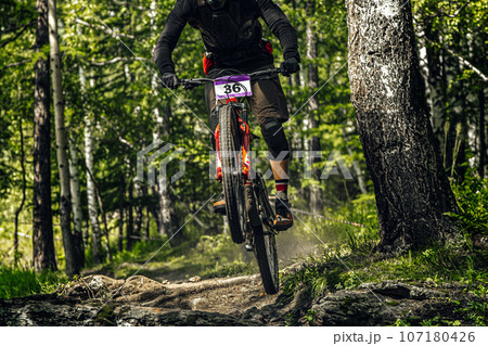 athlete mountainbiker downhill forest trail, racing DH mountain bike, extreme sport games athlete mountainbiker downhill forest trail, racing DH mountain bike, extreme sport games 107180426
