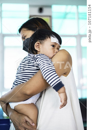 Caring For Child Sick With Influenza, Backgrounds for advertisements and wallpapers in healthcare and medical scene. Actual images in decorating ideas. Caring For Child Sick With Influenza, Backgrounds for advertisements and wallpapers in healthcare and medical scene. Actual images in decorating ideas. 107181154