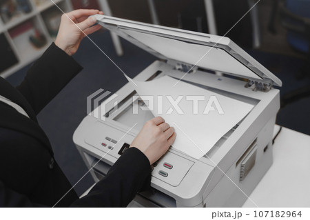 Office Woman's hand with working copier scannerの写真素材 [107182964] - PIXTA