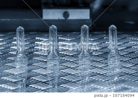 Close up scene of group of preform shape of PET bottle products. Close up scene of group of preform shape of PET bottle products. 107184094