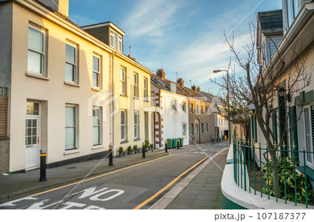 Street with small houses along the road, Belozanne, bailiwick of Jersey, Channel Islands Street with small houses along the road, Belozanne, bailiwick of Jersey, Channel Islands 107187377