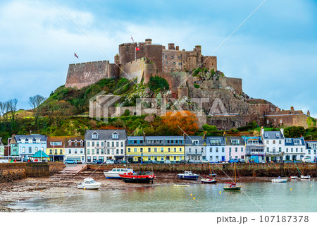 Mount Orgueil castle over the Gorey village promenade with yachts on the shore, Saint Martin, bailiwick of Jersey, Channel Islands, Great Britain Mount Orgueil castle over the Gorey village promenade with yachts on the shore, Saint Martin, bailiwick of Jersey, Channel Islands, Great Britain 107187378