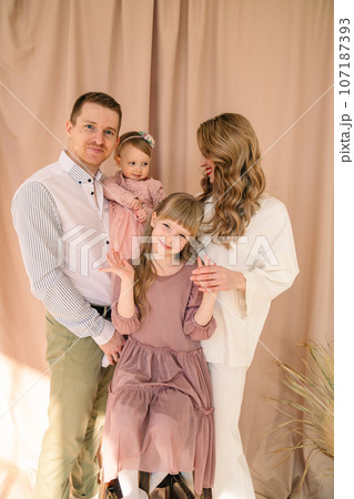 happy family of four father with mother and two daughters happy family of four father with mother and two daughters 107187393