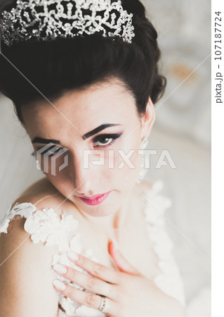 Portrait of beautiful bride with fashion veil at wedding morning Portrait of beautiful bride with fashion veil at wedding morning 107187724
