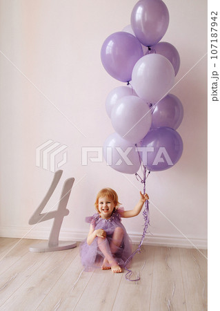 Girl child 4 years old in a dress with white balloons Girl child 4 years old in a dress with white balloons 107187942
