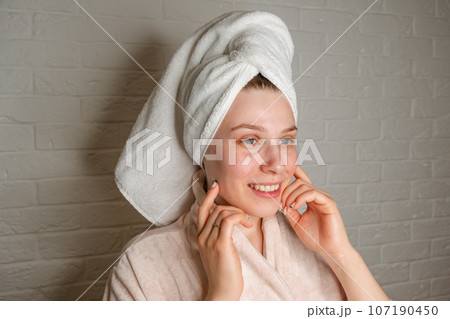 Closeup photo of attractive blonde middle aged woman in white bathrobe 107190450