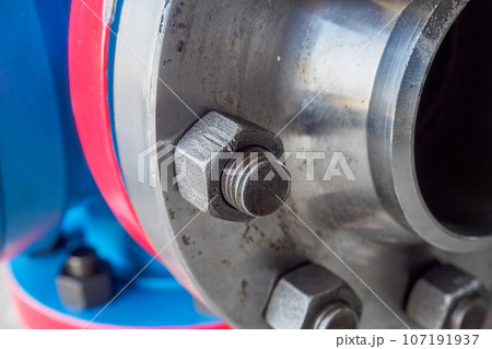 Close-up of steel pipe connection with bolts. Part of gas equipment. Gas industry. Background. Close-up of steel pipe connection with bolts. Part of gas equipment. Gas industry. Background. 107191937