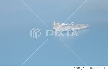 Design Mouth Guard. Transparent Dental Aligners For Human Maxillary And Mandibular Teeth On Blue Background. Braces, Alignment Of Teeth. Orthodontic Concept. Dental Care. Copy Space. Horizontal  107195864