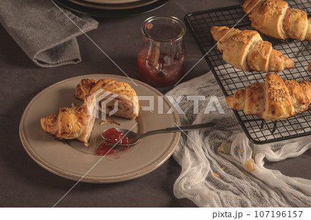 Baked croissants with strawberry jam 107196157