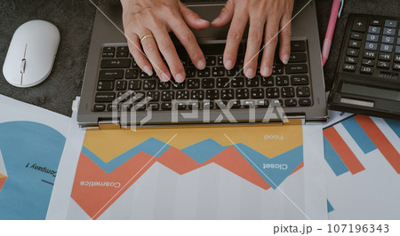 Work desk about data analysis and female hands working with laptop 107196343