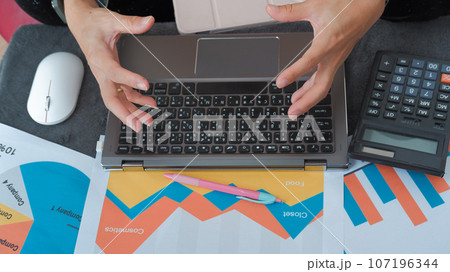 Desk on data analysis and female hand Suitable for making infographics. 107196344
