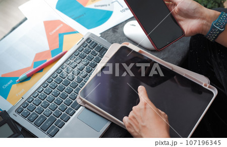 Work desk about data analysis and hands working on mobile laptop. Suitable for making infographics. Work desk about data analysis and hands working on mobile laptop. Suitable for making infographics. 107196345