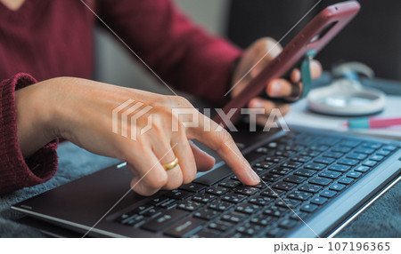 Woman typing work or chatting on laptop Suitable for making infographics. Woman typing work or chatting on laptop Suitable for making infographics. 107196365