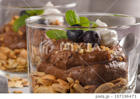 Glass cups of chocolate and chestnuts mousse 107196473
