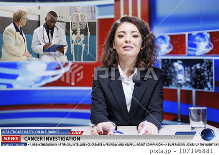 Presenter covers live healthcare news, discussing about medical insurance for patients and attempts to cure cancer. Anchorwoman reading headlines about scientific investigation. 107196881