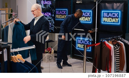 Fashion outlet open doors for clients on black friday, shoppers starting shopping spree with promotions. Diverse buyers ready to get best deals in department store, discount. Tripod shot. 107196887