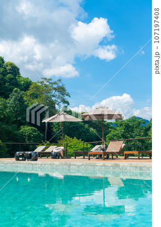 bed pool with umbrella around swimming pool bed pool with umbrella around swimming pool 107197408