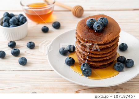 chocolate pancake stack with blueberry and honey 107197457