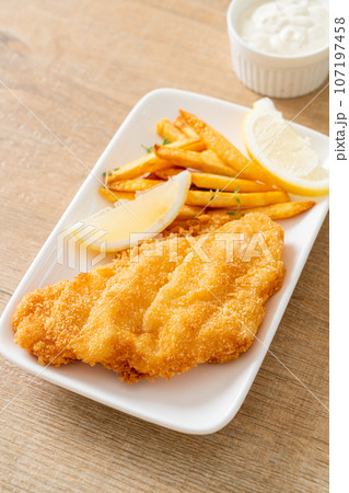 fish and chips - fried fish fillet with potatoes chips fish and chips - fried fish fillet with potatoes chips 107197458