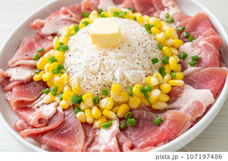 fresh pork raw sliced with rice and corn on plate and ready to cook 107197486