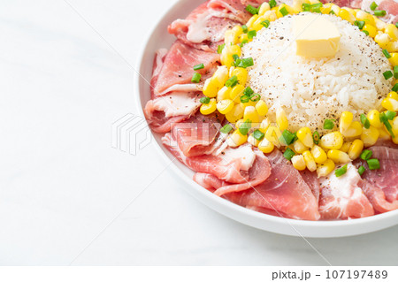 fresh pork raw sliced with rice and corn on plate and ready to cook 107197489