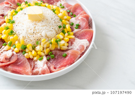 fresh pork raw sliced with rice and corn on plate and ready to cook 107197490