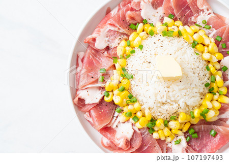 fresh pork raw sliced with rice and corn on plate and ready to cook 107197493