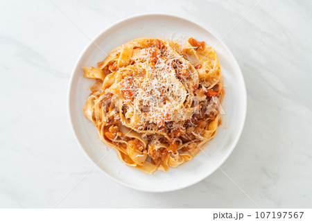Homemade pasta fettuccine bolognese with cheese 107197567