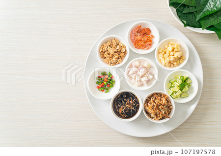 Miang kham - A royal leaf wrap appetizer Miang kham - A royal leaf wrap appetizer 107197578