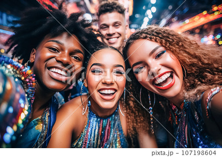 A company of joyful happy young people in sparkling dresses clothes smile and pose for camera. Party, disco nightclub A company of joyful happy young people in sparkling dresses clothes smile and pose for camera. Party, disco nightclub 107198604
