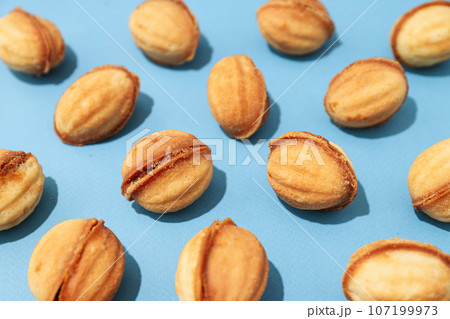Cookies in the form of nuts on a blue background 107199973