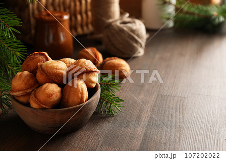 Cookies Nuts in a bowl with a sprig of needles 107202022